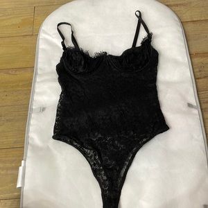 A Medium black mesh bodysuit from Fashion Nova